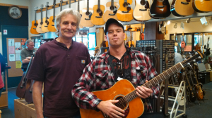 Afganistan War Veteran named Anthony, poses with Richard Johnston, co-owner of Gryphon Stringed Instruments.