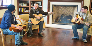 Larry Chung teaching veterans to play guitar at the Veterans Administration