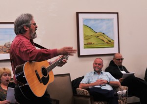 Director Richard Harrell leads veterans in song at a Heroes' Voices Workshop.